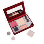 Collector's Kit – red velvet palette with mirror, makeup products and applicators on white background – makeup