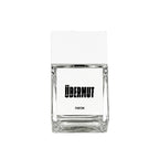 Übermut Parfum – clear glass bottle with white cap, white label and black text, white background – perfume
