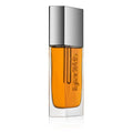Kjaer Weis The Beautiful Oil – durchsichtige Glasflasche mit orangefarbenem Öl, silberner Kappe, weißem Hintergrund – Hautpflege