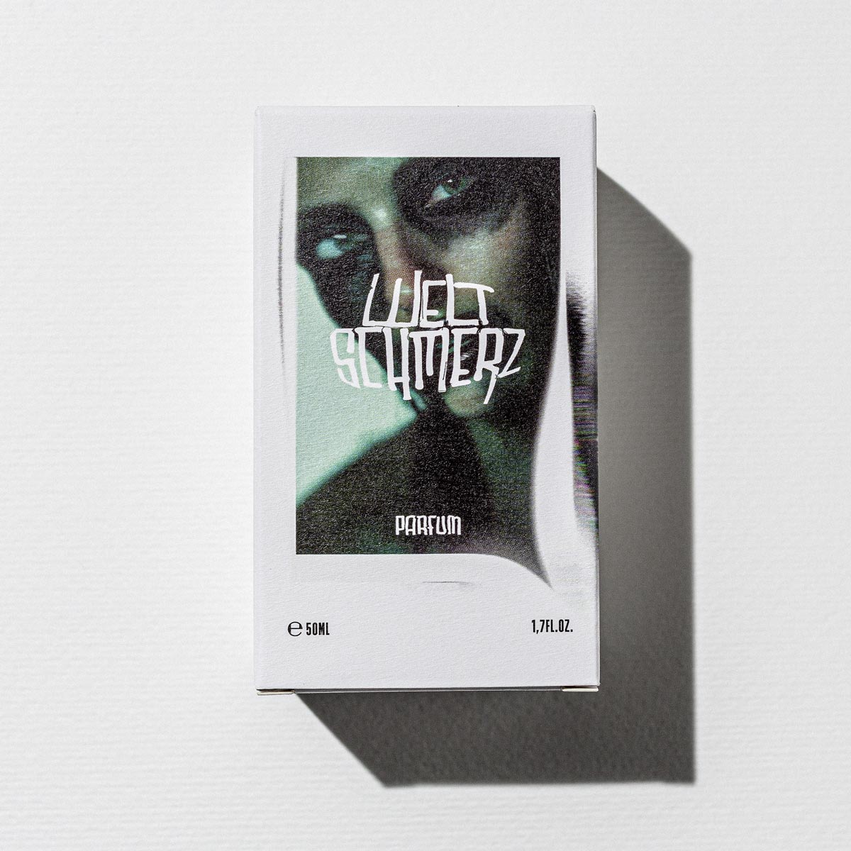 Weltschmerz Parfum – white box 50ml, green-black artwork, white background – perfume