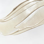 The Beautiful Primer – creamy texture with pearlescent shimmer on white background – makeup base