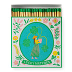 Lucky Matches – colorful matchbox with clover design, green tips, white background – decorative item