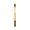 Bamboo toothbrush with green handle and gold logo, black bristles, white background – oral care