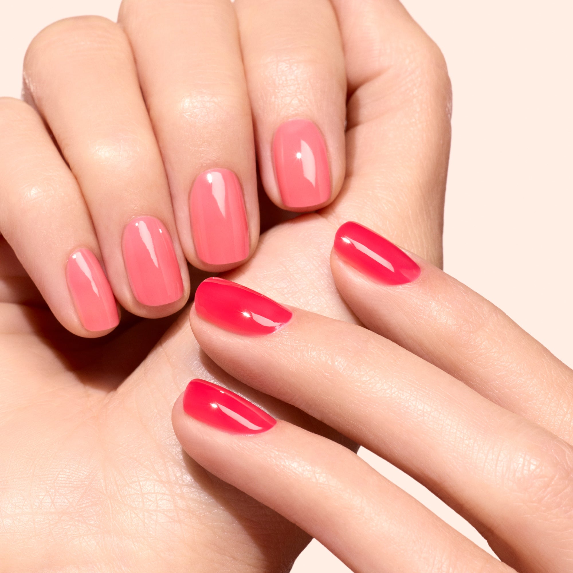 Hands with pink and coral nails from the All About Jellies Kit for manicure