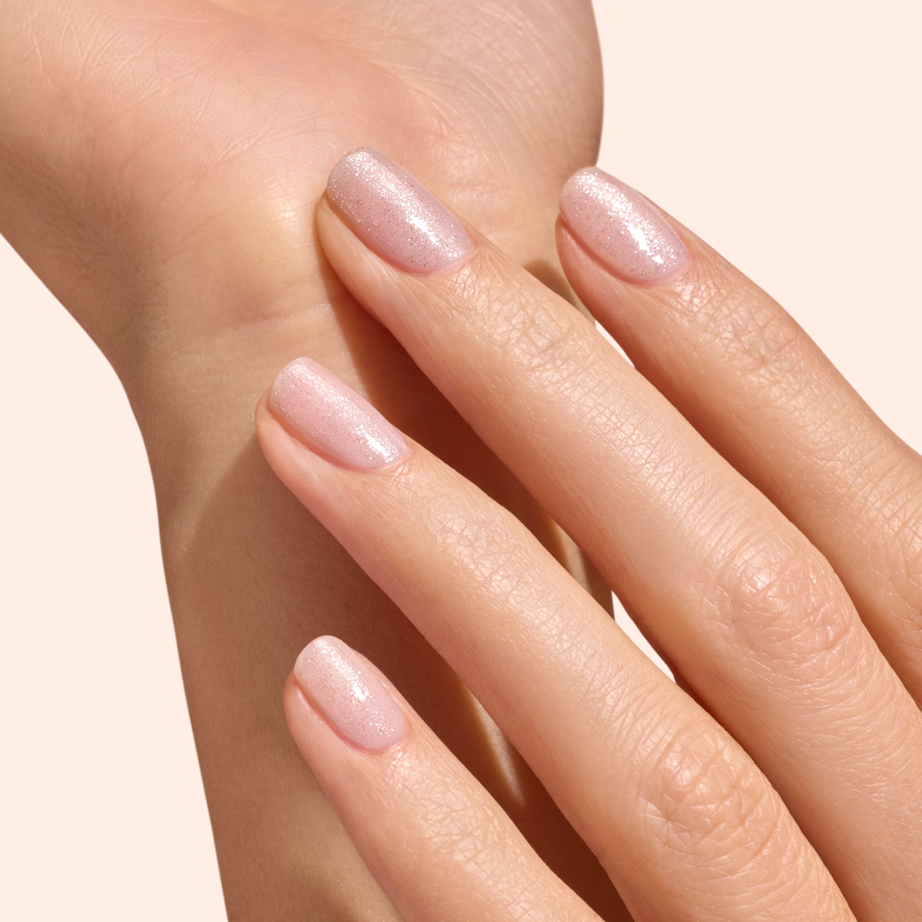 Hand with nailpolish and silver topcoat