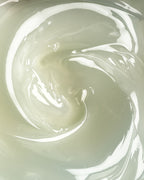 Botanical Cleanser Caulis – creamy texture in soft green, macro shot – skin cleansing