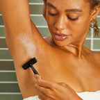 Perfect Glide Safety Razor Black – schwarzer Rasierer in Hand, Achselrasur mit Schaum, grüner Fliesen-Hintergrund – Körperpflege