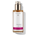 Dr. Hauschka Haartonikum – brown glass bottle with spray nozzle, white label and purple stripe, white background – hair care