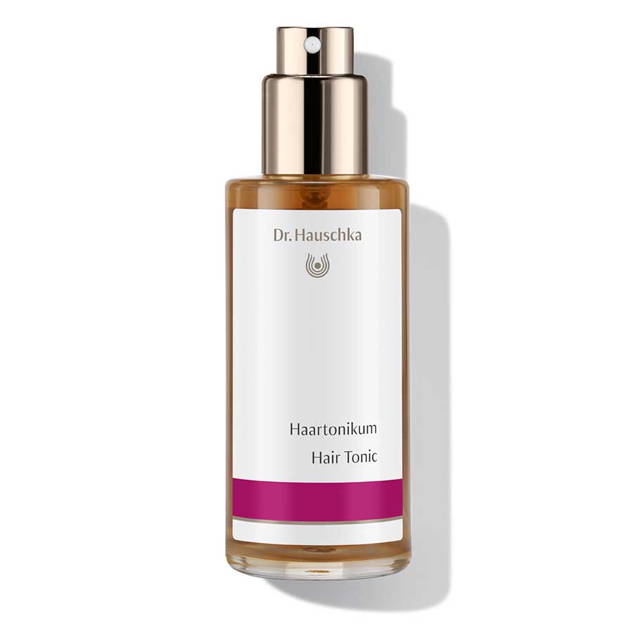 Dr. Hauschka Haartonikum – braune Glasflasche mit Sprühkopf, weißem Etikett und lila Streifen, weißer Hintergrund – Haarpflege