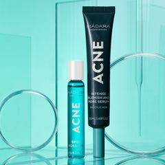 Mádara Acne Acute Spot Roll-on in a blue glass bottle with white closure next to a tube.