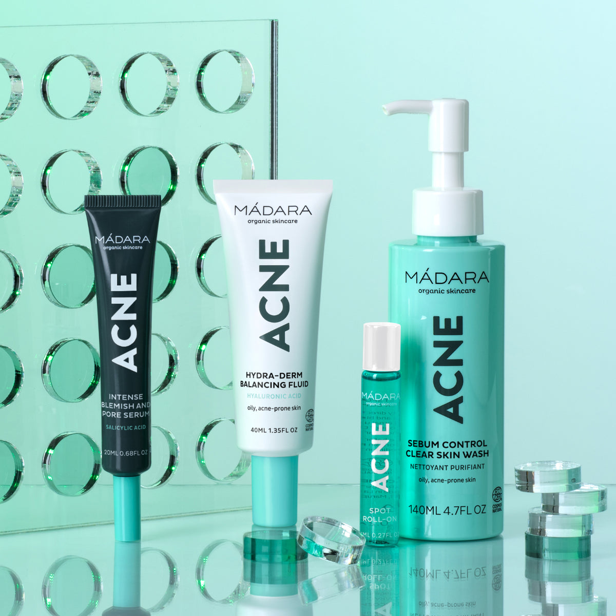 Mádara Acne Acute Spot Roll-on, shown together with other products from the range.