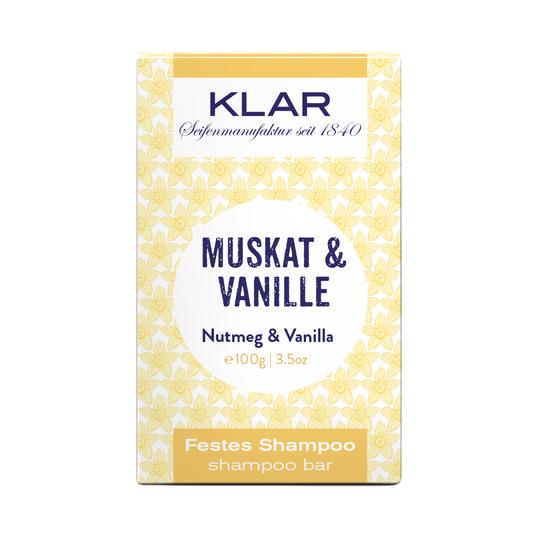 KLAR Festes Shampoo Muskat & Vanille – 100g, gelb-weiße Verpackung mit Blumenmuster, weißer Hintergrund – Haarpflege