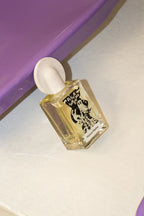 Maison Matine Disco Inferno Eau de Parfum – square glass bottle with white spray cap, purple background – perfume