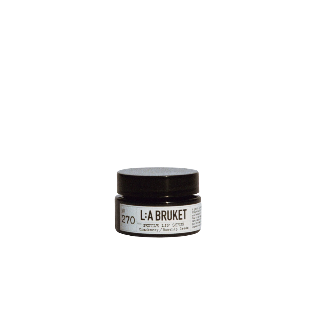 L:A BRUKET Nr. 270 Sanfter Lippenpeeling – schwarzer Glasbehälter, weißes Etikett, schwarzer Deckel, weißer Hintergrund – Lippenpflege