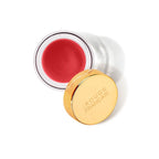 Offenes Glas mit rotem Lippenstift und goldener Kappe von Rouge Français.