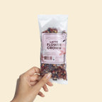 Queen of Cacao Latte Flower Crown – clear pouch packaging with pink label, 10g, cream background – beauty