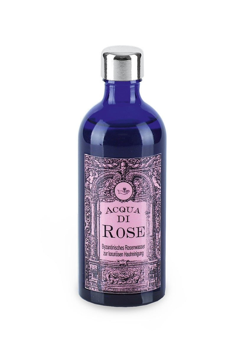 Aqua di Rose – dunkelblaue Glasflasche mit silbernem Deckel, rosafarbenes Etikett, weißer Hintergrund – Hautreinigung