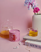 She Woke Up and Conquered the World Green Tea – pink cylindrical packaging, pink background – skin care