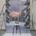 No. 331 Candle Winter Pine – green glass jar, white label, on black stool against snowy forest backdrop – scented candle