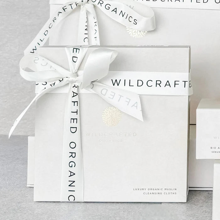 Wildcrafted Organics Luxury Muslin Cleansing Cloths – white gift box set with ribbon, grey background – skin care