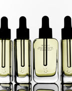 Botanical Face Oil Armonia – clear glass bottle with black dropper cap, creamy liquid, white background – skin care