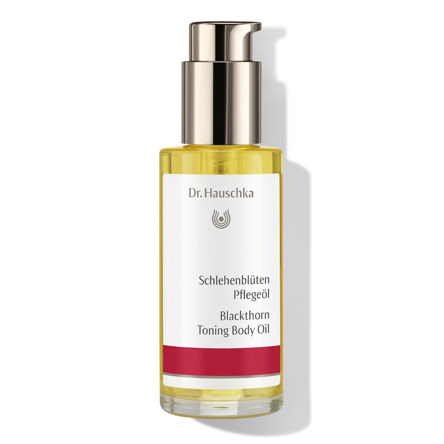 Dr. Hauschka Schlehenblüten Pflegeöl – klares Glasfläschchen mit Pumpverschluss, weiß-rotes Etikett, weißer Hintergrund – Körperpflege