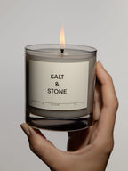 Salt & Stone Candle Santal & Vetiver – 8.5 oz glass, lit, white background – scented candles
