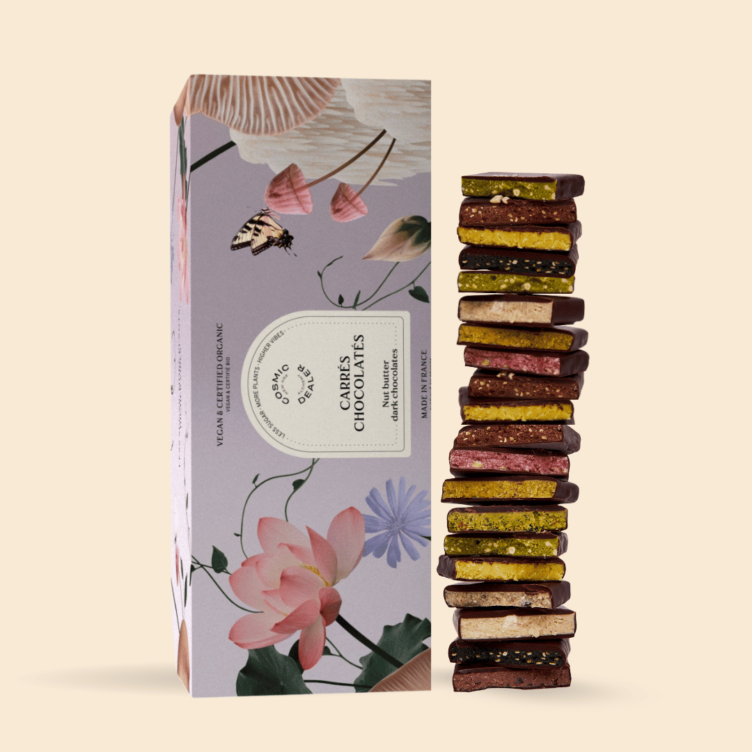 Osma Dealer Nut Butter Schokoladen – lila Kartonbox mit Blumen, 20 Stück, cremefarbener Hintergrund – vegane Süßigkeit