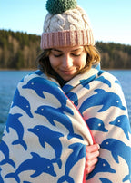 Jumping Dolphins Organic Cotton Bath Towel – blue and white with dolphin print, woman by lake – wellness & relaxation