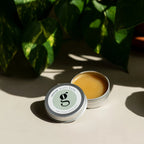 Rescue Multi Balm – silver metal tin 30ml, open with creamy balm, beige background with green leaves – skin care