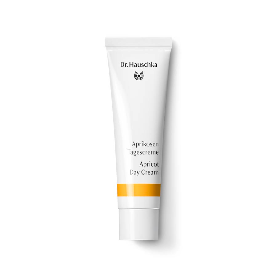 Dr. Hauschka Aprikosen Tagescreme – weiße Tube mit orangefarbenem Streifen, weißem Deckel, weißem Hintergrund – Hautpflege
