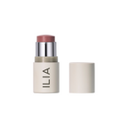 ILIA Multi-stick in a beige tube with silver trim and white cap on a white background, makeup.