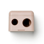 Precision Dual Sharpener, rose-colored dual pencil sharpener on white background, makeup accessory.