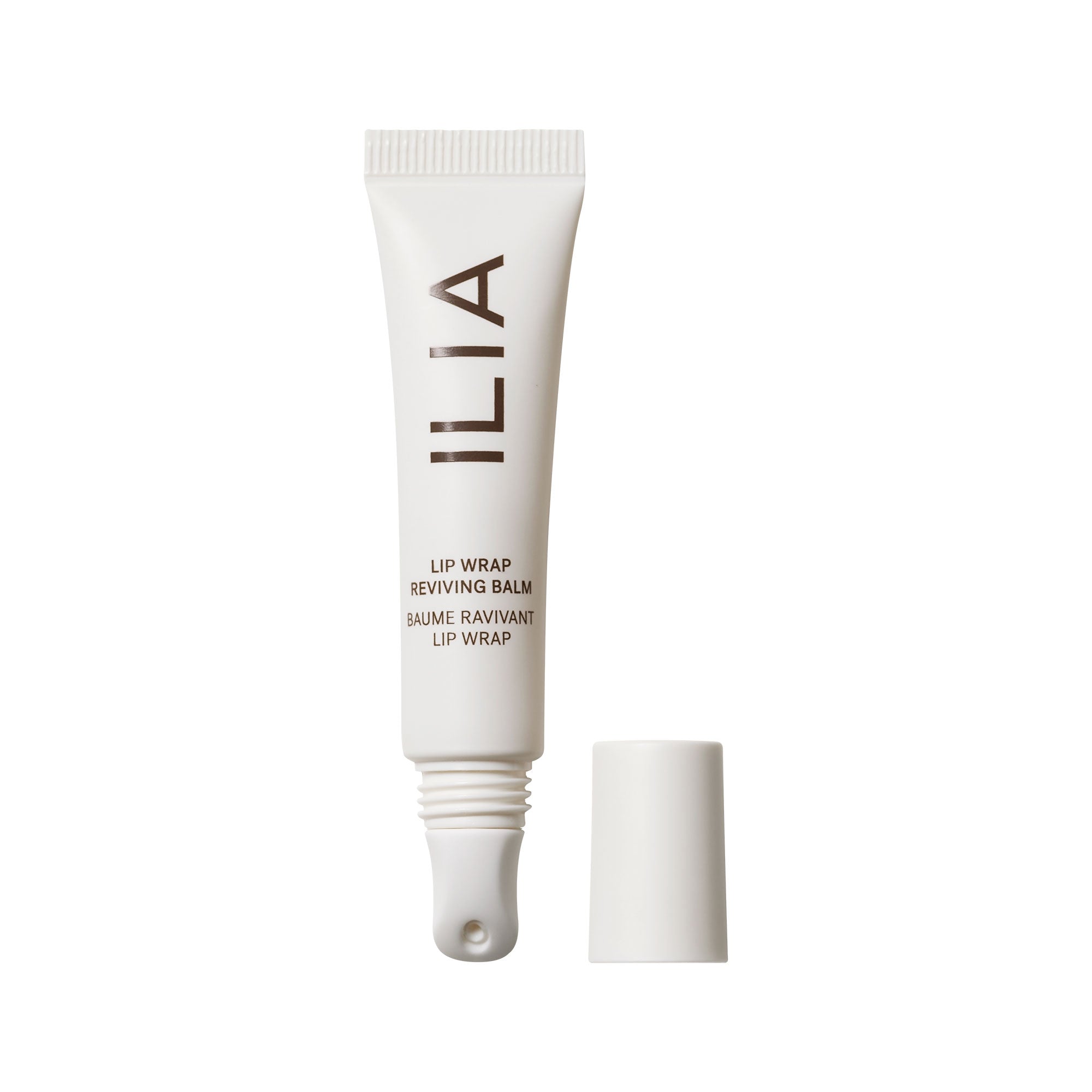 White tube of ILIA Lip Wrap Reviving Balm with white cap on white background, lip care.