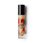 Susanne Kaufman Lip Oil in a bottle with a black cap on a white background, lip care