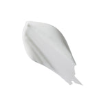 Close-up of the white texture of the nourishing night cream on a white background for skin care.
