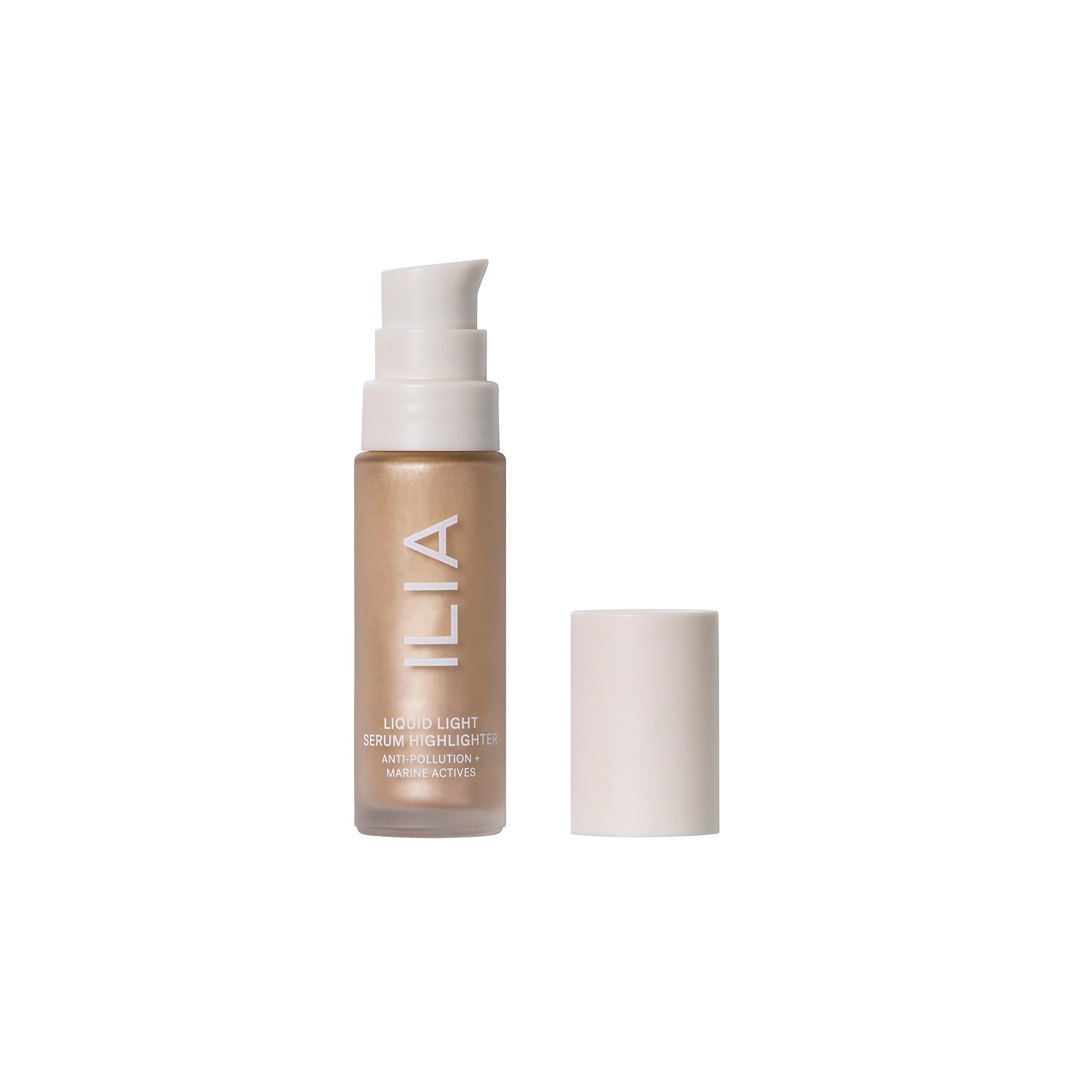 ILIA Liquid Light Serum Highlighter in a gold with a white pump on a white background, skin care