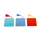 Three square small pouches in turquoise, blue, and red, each featuring a coloured tassel.