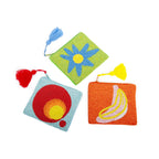 Three small embroidered pouches in green with a flower, blue with circles, and orange with a banana.