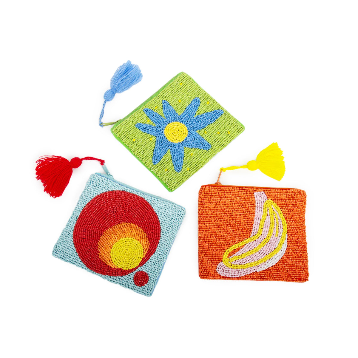 Three small embroidered pouches in green with a flower, blue with circles, and orange with a banana.