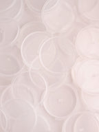 Small white plastic jars with lids for skin care sample