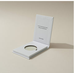 Tenth Muse 0.1 Date Night Solid Perfume in an open white compact against a beige background.