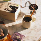 Cosmic Dealer I Quit Coffee Collection – beige box with black silhouette, purple sachet, marble background – beauty