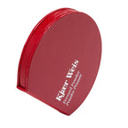 Kjaer Weis Pressed Powder – red powder compact with textured surface, white lettering, white background – makeup
