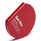 Kjaer Weis Lightslip Powder Highlighter – round red case with textured surface, white background – face highlighter