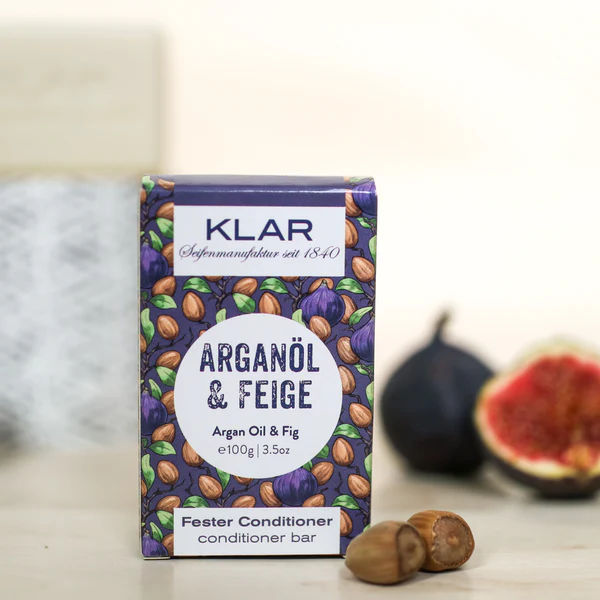 KLAR Fester Conditioner Arganöl & Feige – 100g Verpackung, lila mit Motiv, weißer Hintergrund – Haarpflege