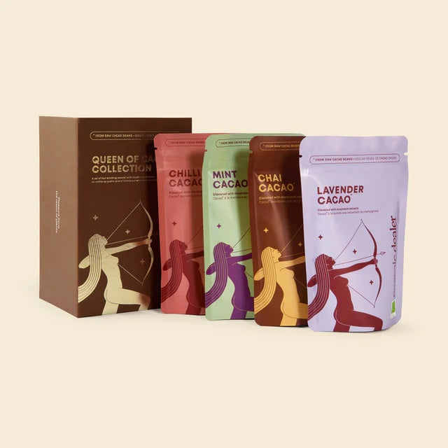 Queen of Cacao Collection – four colorful stand-up pouches, brown gift box, cream background – beauty set