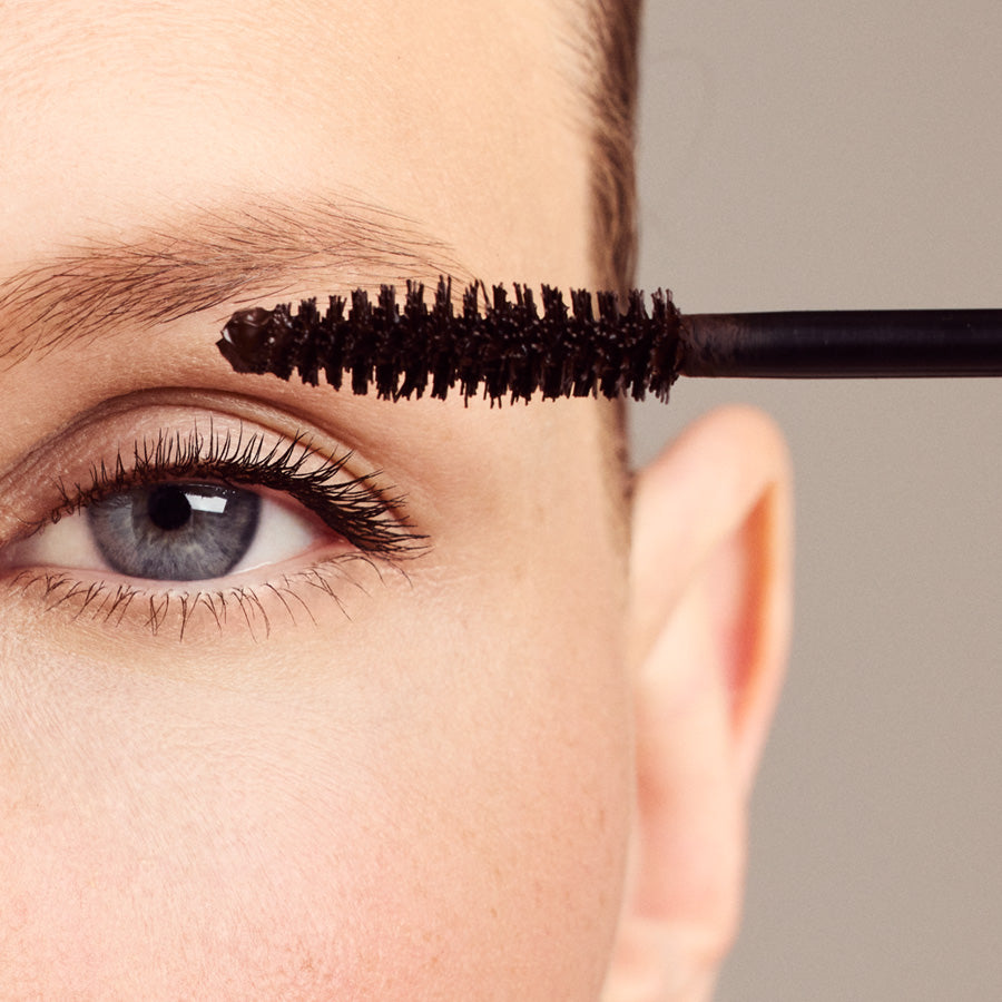Long Lasting Mascara 02 Brown – brown mascara applied to blue eye, neutral background – eye makeup