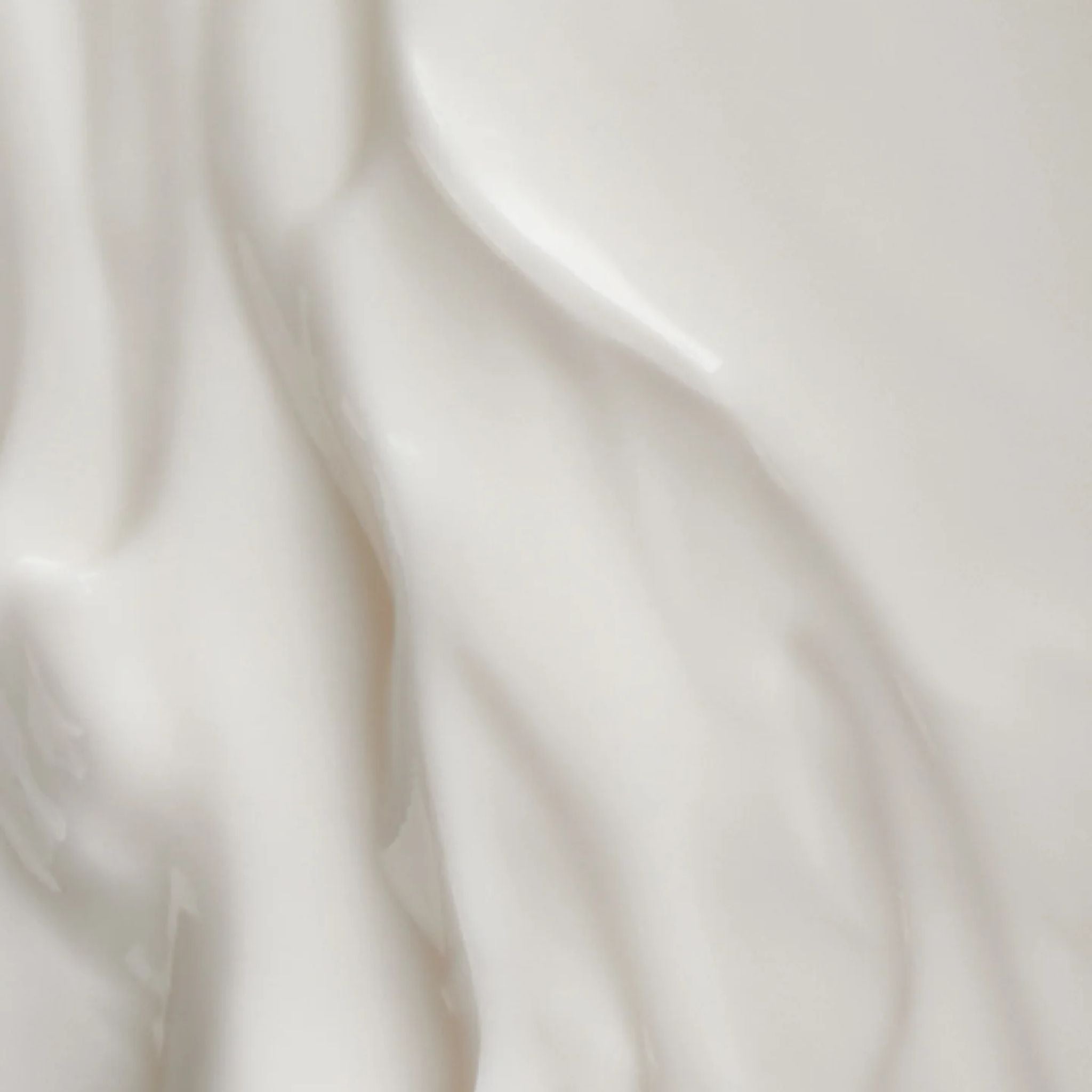 Close-up of the creamy texture of Bergamot Pear body milk for skin care