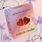 Cosmic Dealer Nut Butter Chocolate – gradient cardboard box with heart design, purple flower background – candy
